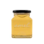 Miód akacjowy w szklanym słoiku